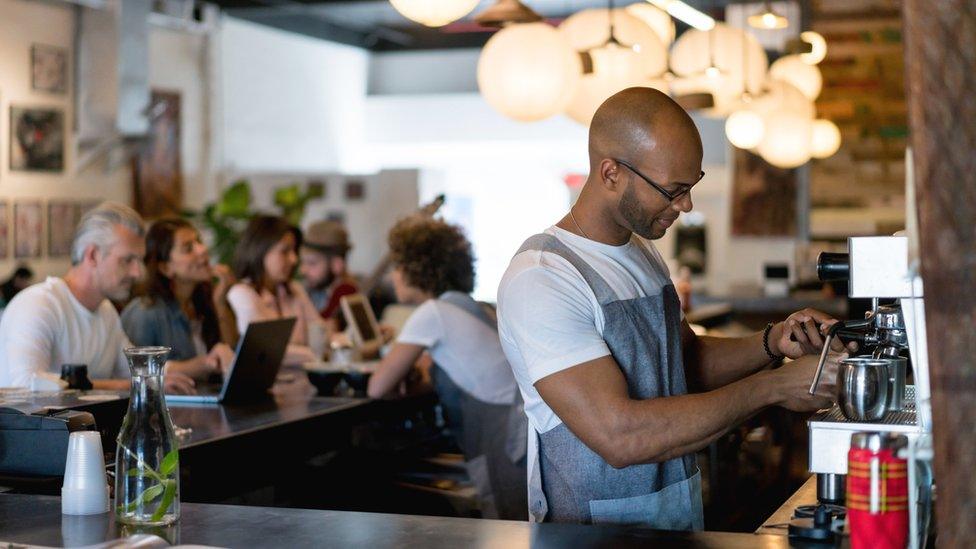 A barista making coffee in a cafe