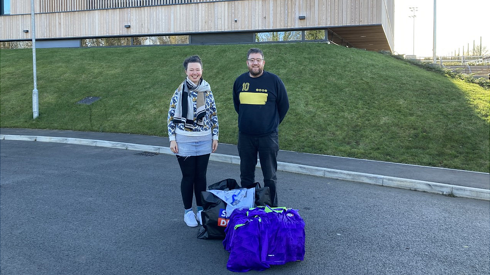 Lizzie Watson with James Healey of Kits to Kids outside Bristol City Football Club