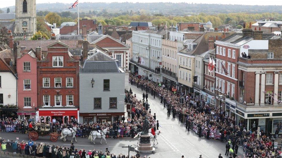 Crowds cheer Jack Brooksbank and Princess Eugenie as they embark on a carriage ride following their wedding at Windsor Castle