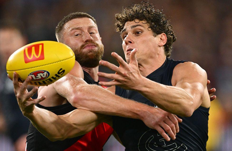 Charlie Curnow marks the ball in front of Jayden Laverde during the match between Carlton Blues and Essendon Bombers at Melbourne Cricket Ground. Photo by Quinn Rooney