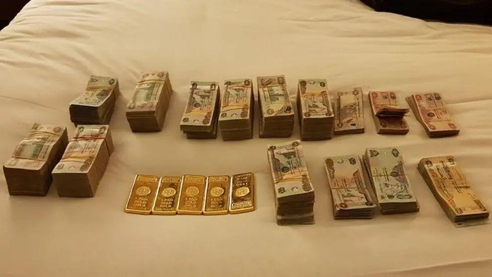 Stacks of foreign notes piled on a bed

