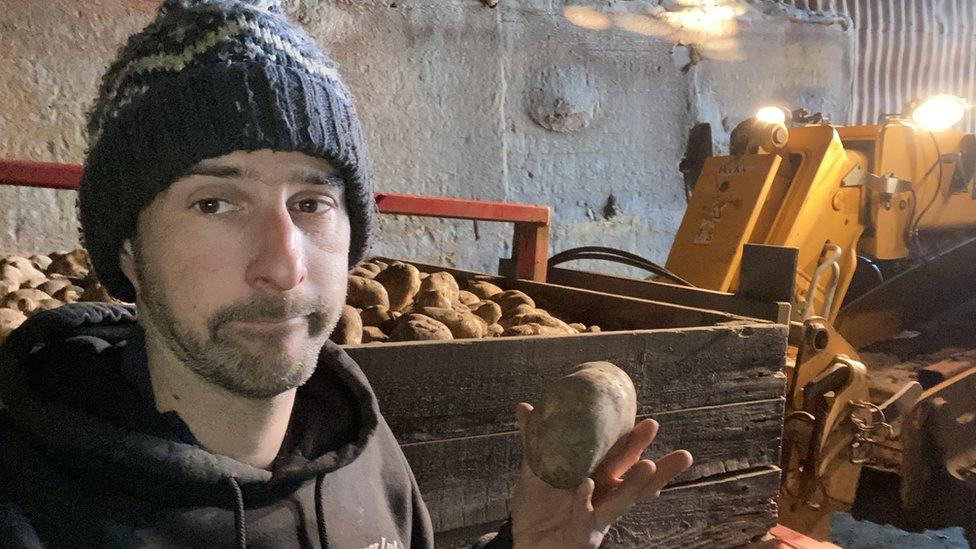 man holding a potato