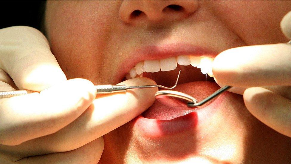 Dentist checking the mouth of a child