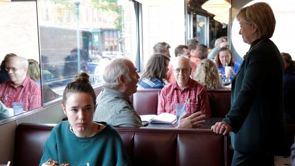 Hillary Clinton speaks to customers at the Court Street Diner during a campaign stop in Athens, West Virginia.