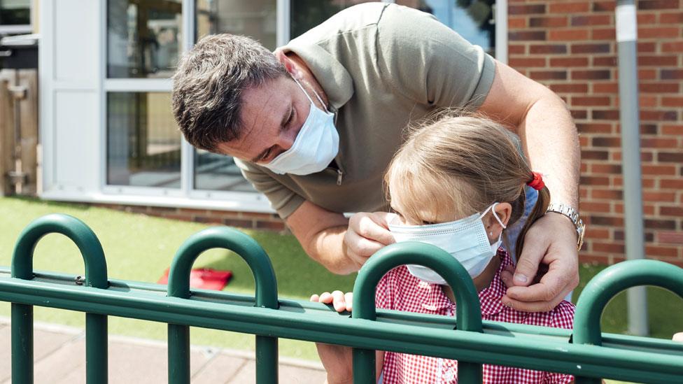 Stock image of a father and child at school