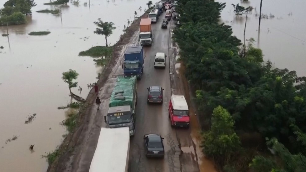 Cars driving and evacuating a flooded area