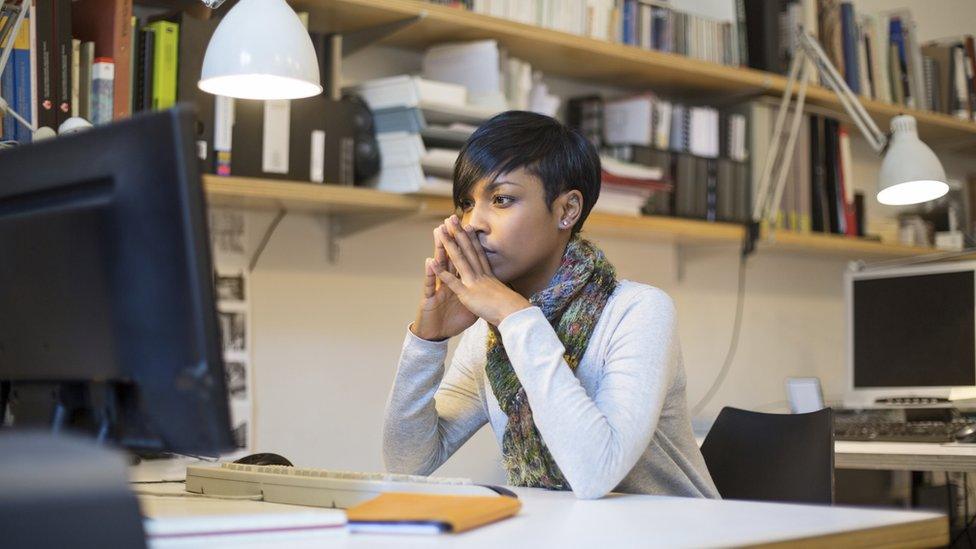 younh woman looking at business plan