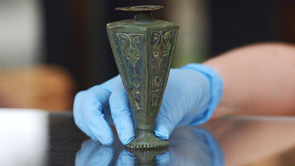 A 1st Century AD copper alloy and enamelled perfume vase from a grave