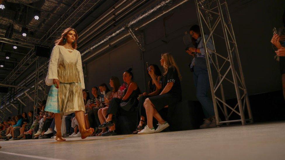 Models present the Sashina Designer label collection during Moscow Fashion Week at Zaryade Park in Moscow, Russia on June 24, 2022.