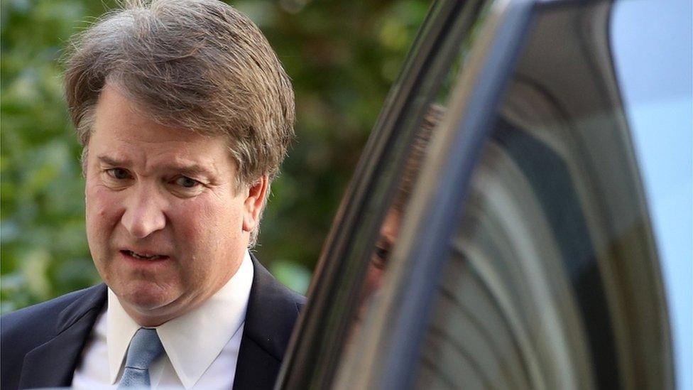 Kavanaugh standing by his car