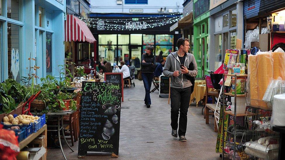 People stroll through Brixton Village, south London