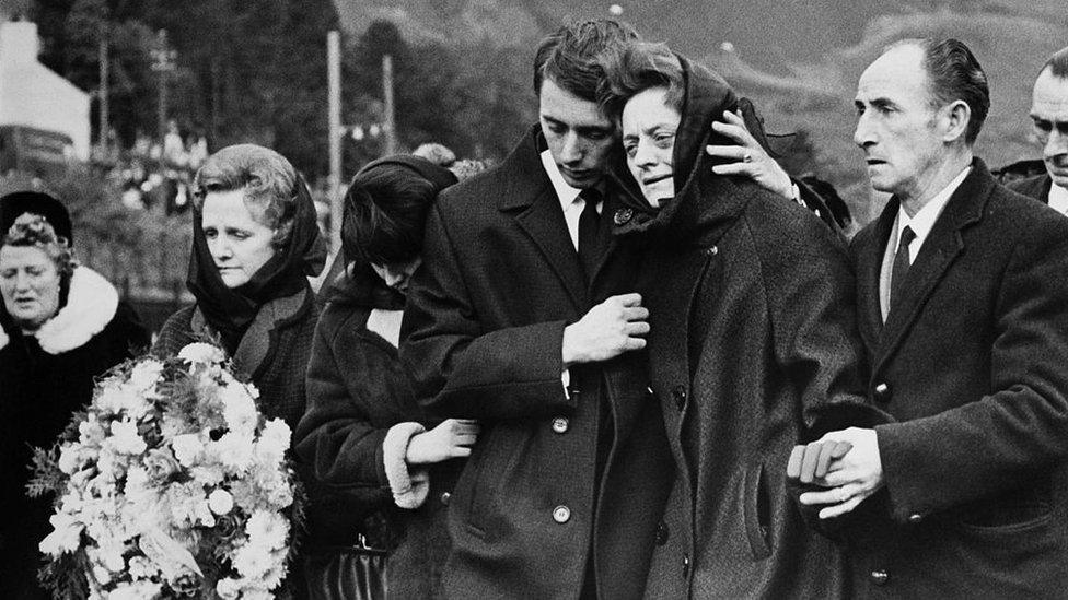 Mourners at the funeral following the tragedy