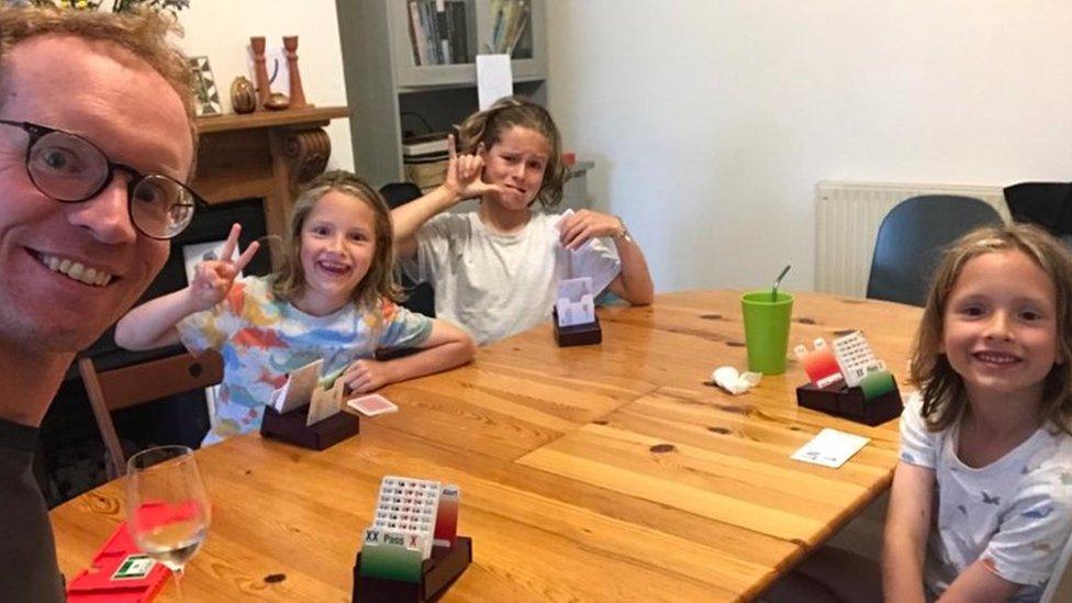 George playing Bridge round a table with his family