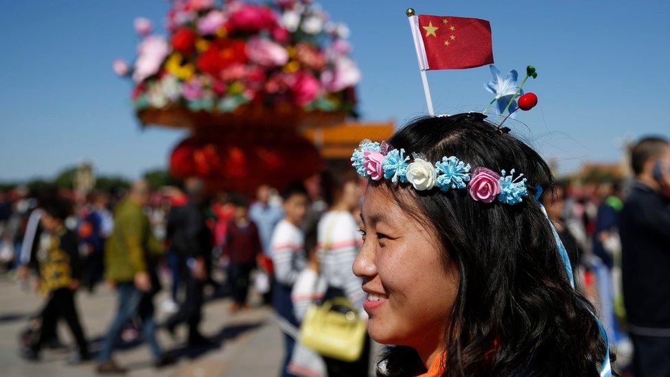 A small Chinese national flag fixed in a woman's hair in Tiananmen Square during China's national day