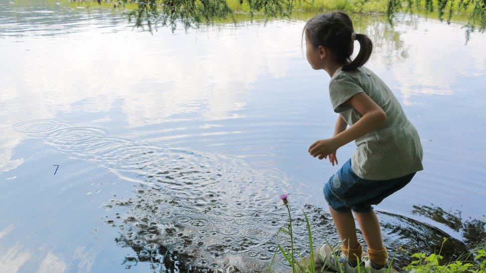 Girl skimming stones