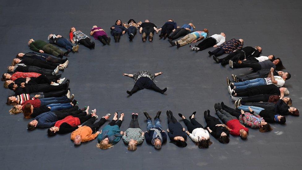 People lying down in the Turbine Hall at the Tate Modern