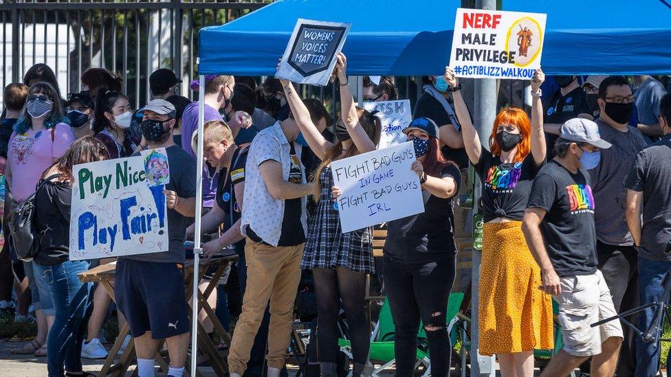 Blizzard employees hold placards outside the Irvine, California office on 28 July