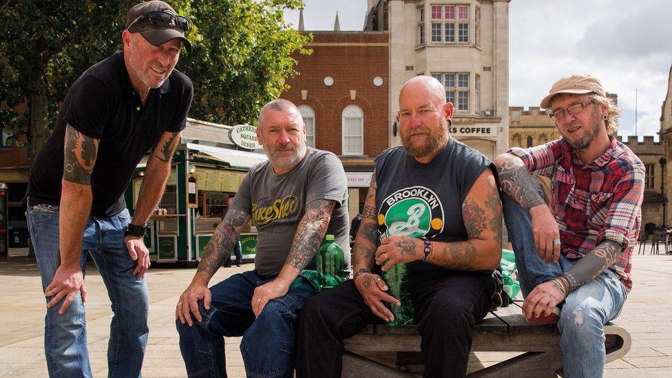 Four men posing for a photo in Peterborough city centre