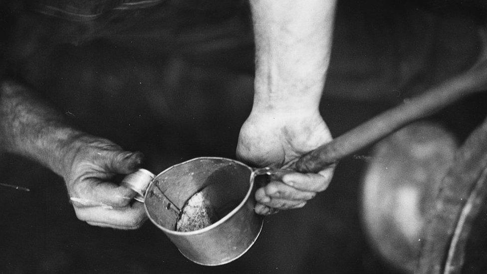 A man producing poitin