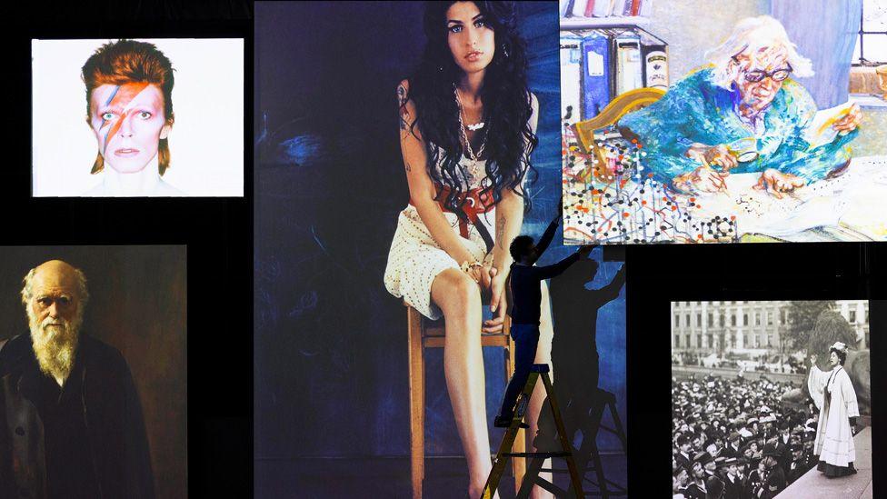 Screens showing portraits of Amy Winehouse, David Bowie, Dorothy Crowfoot Hodgkin, Emmeline Pankhurst and Charles Darwin, with a silhouetted worker on a ladder in front of them