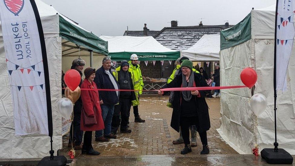 A ribbon being cut by different councillors as the new Elland Market is opened