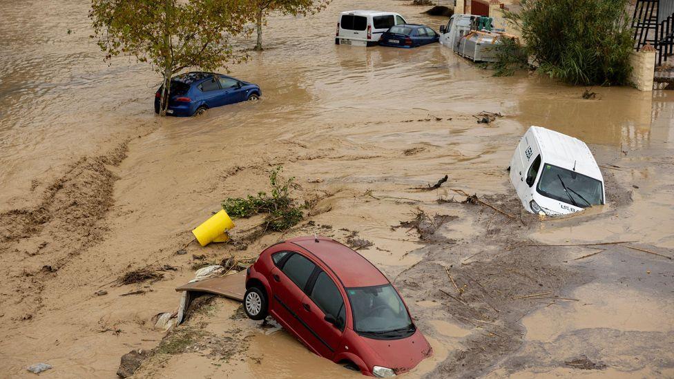 A view of partially submerged vehicles after the Guadalhorce River burst its banks following torrential rains in Alora, Malaga, Spain