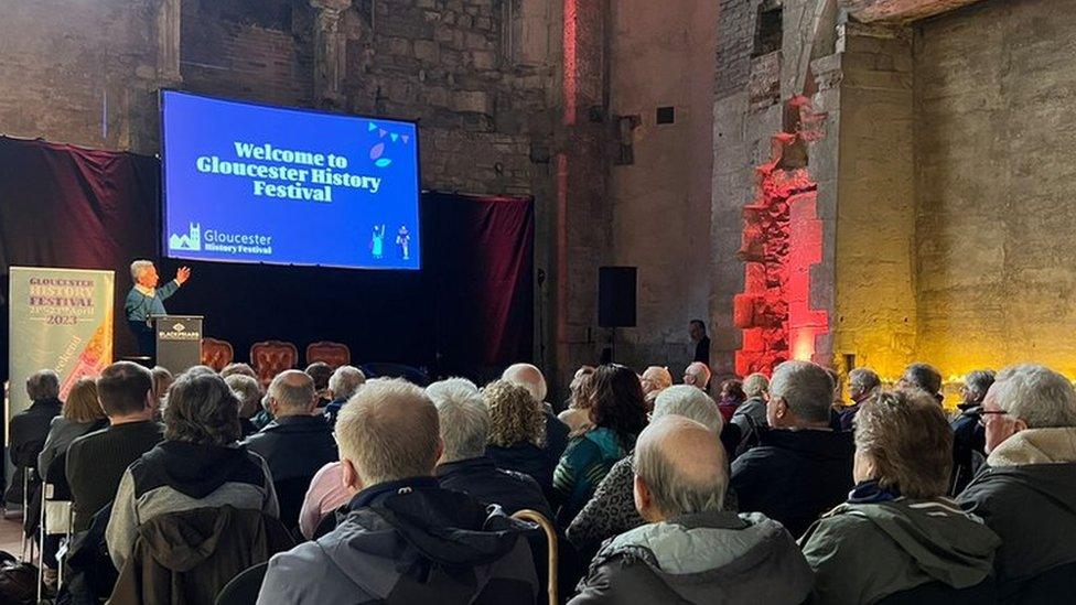 Group of people sitting in Gloucester Cathedral for the film screening