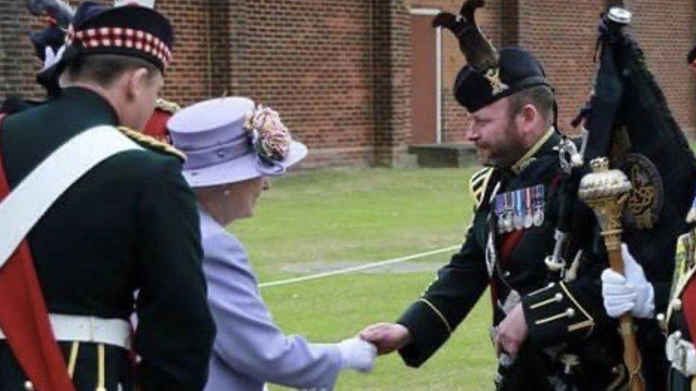 Maj Scott Methven shaking hands with the Queen