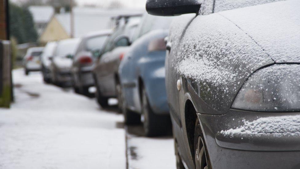 Cars covered in ice and snow