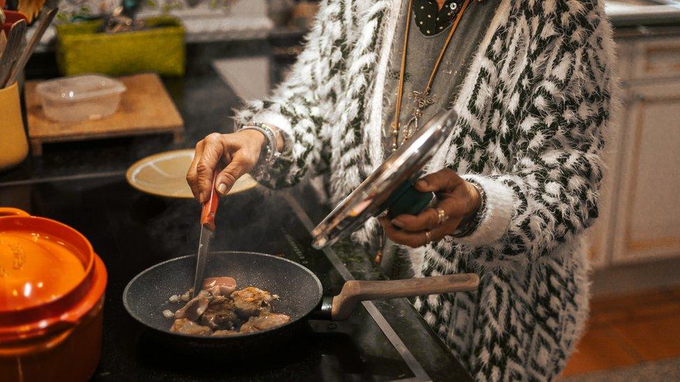 Woman cooking on a stove