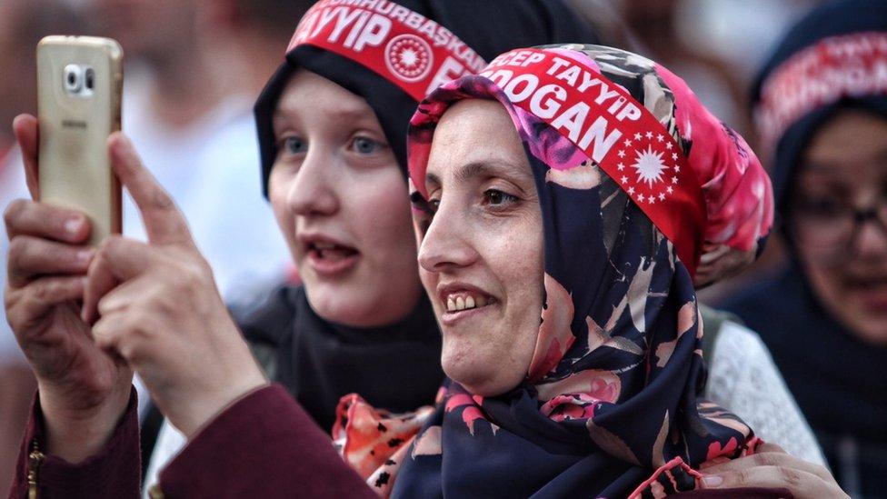 Supporters of Turkish President Recep Tayyip Erdogan take selfies as they gather in Istanbul's Taksim Square on July 17