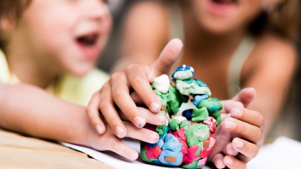 Children playing with plasticine