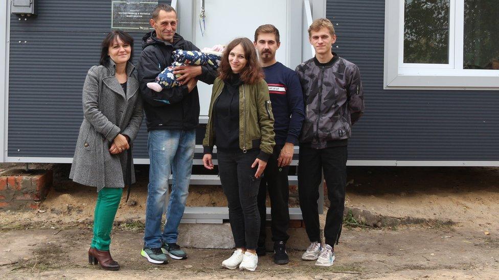 Pylypenko family in front of their new HOMErs house