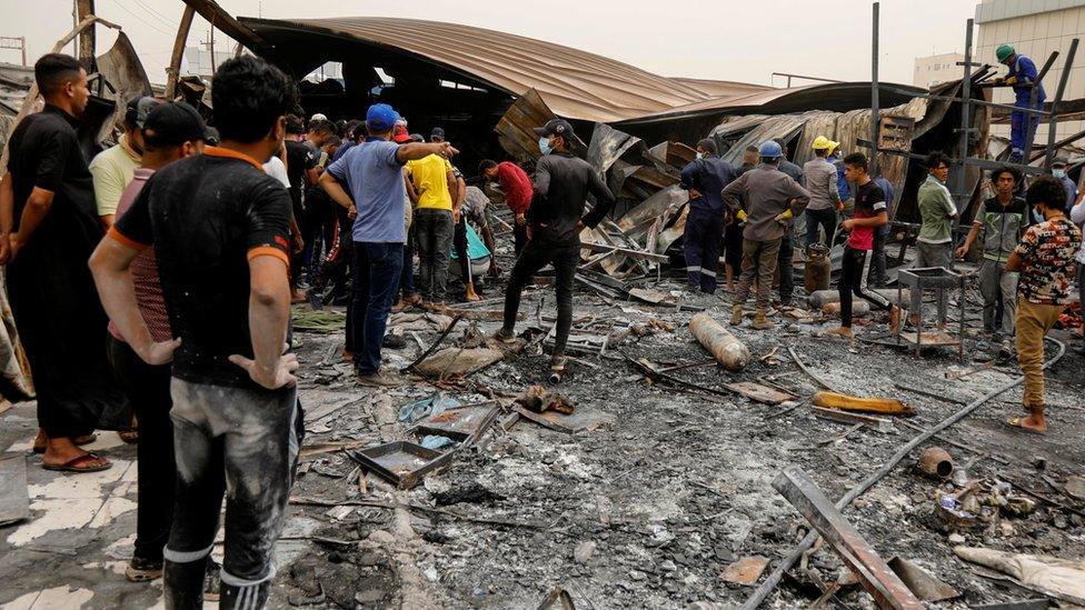 Relatives inspect the remains of the hospital