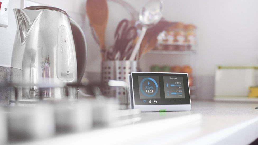 Smart meter in the kitchen of a home showing current energy costs