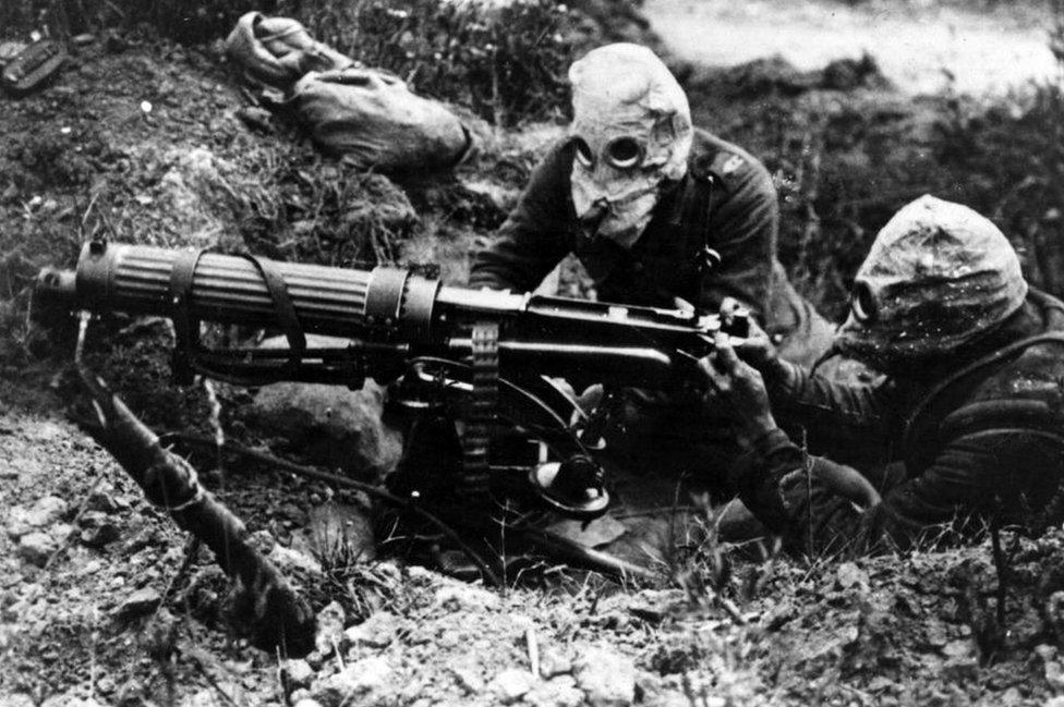 Photograph of gas-masked men of the British Machine Gun Corps with a Vickers machine gun during the first battle of the Somme