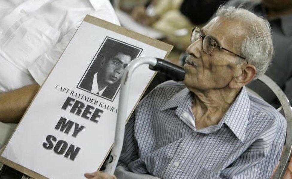 L. D. Kaura holds a photo of his missing son Captain Ravinder Kaura during a press conference organised by the Missing Defence Personnel Relatives Association in New Delhi, 05 September 2005.