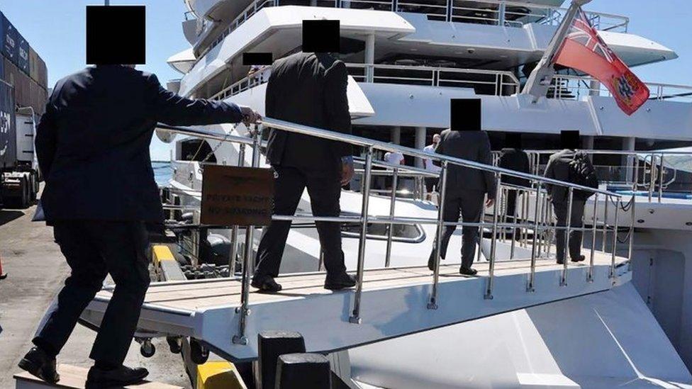 An FBI handout picture shows US agents boarding the 106m yacht in April