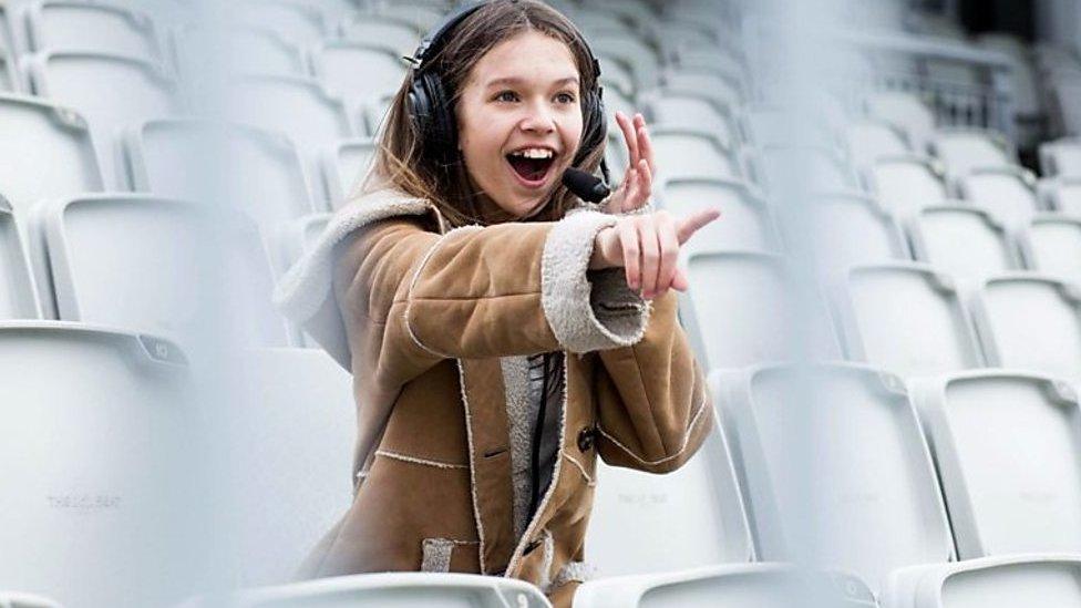 A young girl watching sport