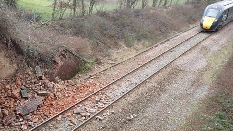 The collapsed wall and rear of the train