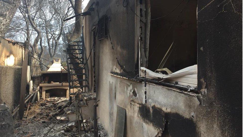 A burnt out building following wildfires in Greece