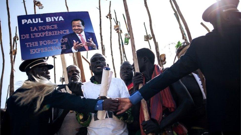 President Paul Biya are contained by policemen during an electoral meeting at the stadium in Maroua during his visit in the Far North Region of Cameroon, on September 29, 2018.