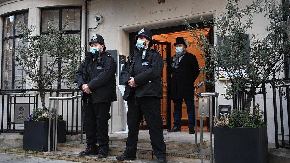 Police officers guard the entrance to the King Edward VII Hospital where the Duke of Edinburgh has been admitted as a precaution