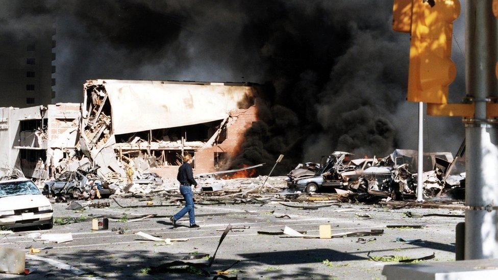 Cars on fie among damaged building at scene of bombing