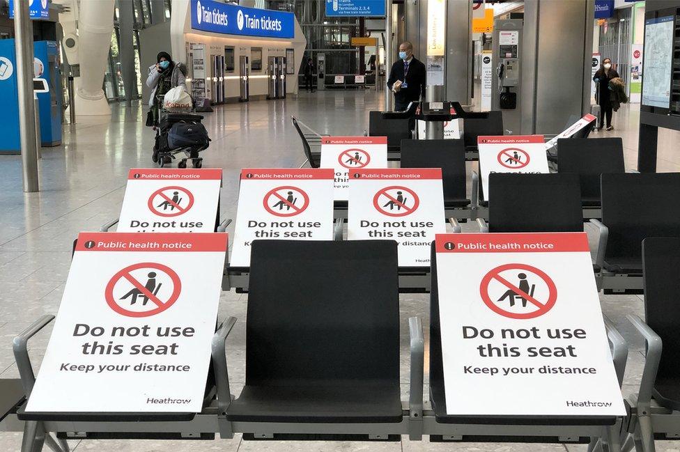 Heathrow airport with seats showing 'do not use' signs on them