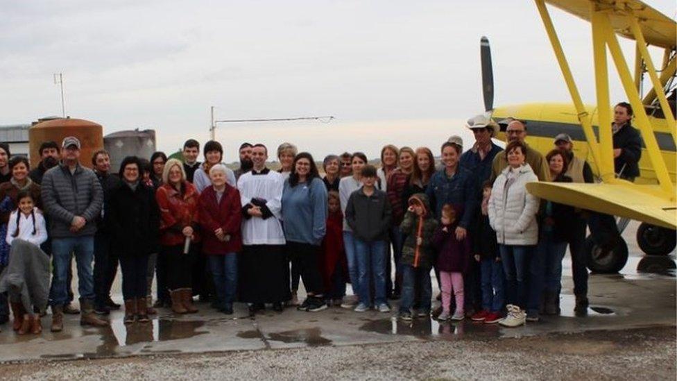 Parishioners of Cow Island in Louisiana before holy water is sprayed from a plane, 24 Dec 2019