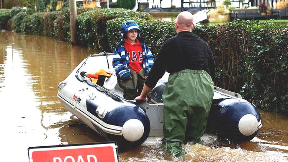 Jack, aged 7, is rescued as the village of Severn Stoke is cut off amid flooding after heavy rain from Storm Henk