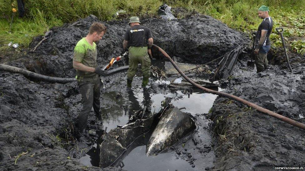 Men working at the site of the wreck