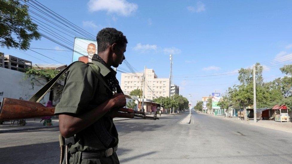 Somali policeman stands guard along a road which was blocked to control motor vehicle traffic, during a security lock down in Somalia's capital Mogadishu, February 7, 2017.