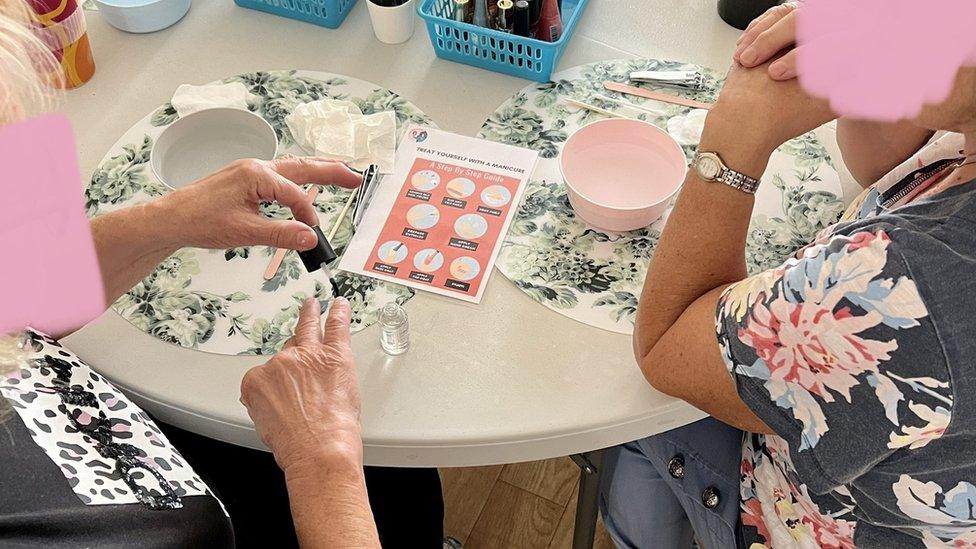 Women taking part in a manicure workshop